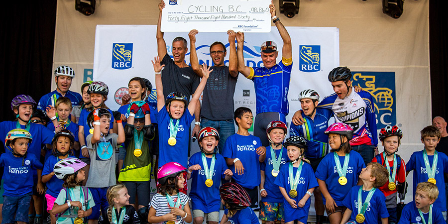 iRide kids on stage at RBC GranFondo Whistler receiving a huge cheque