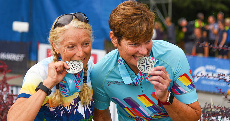 Two female riders celebrate with their medals